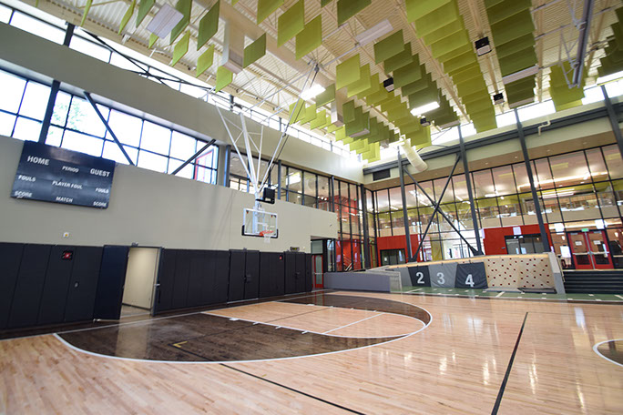 C. Mark Openshaw Education Center and Office Building finished gym with basketball hoop and scoreboard