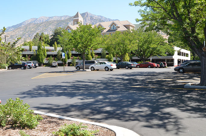 BYU N. Eldon Tanner Building Parking Structure and parking area with Gordon B. Hinckley alumni center in background
